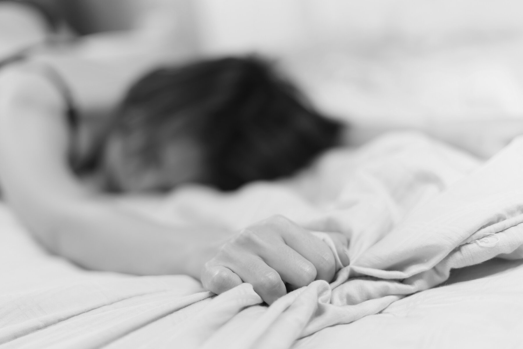 Woman Clutching Blanket in Pleasure 