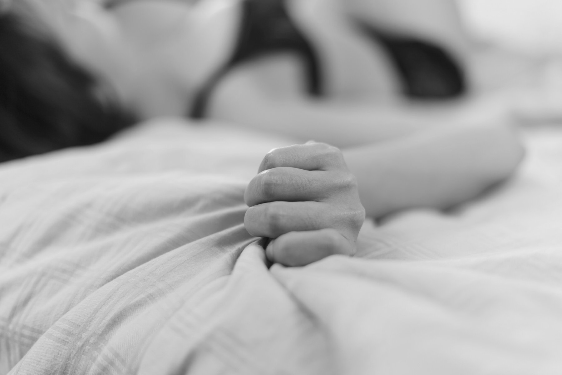 Woman Holding Bed Sheet Tightly 